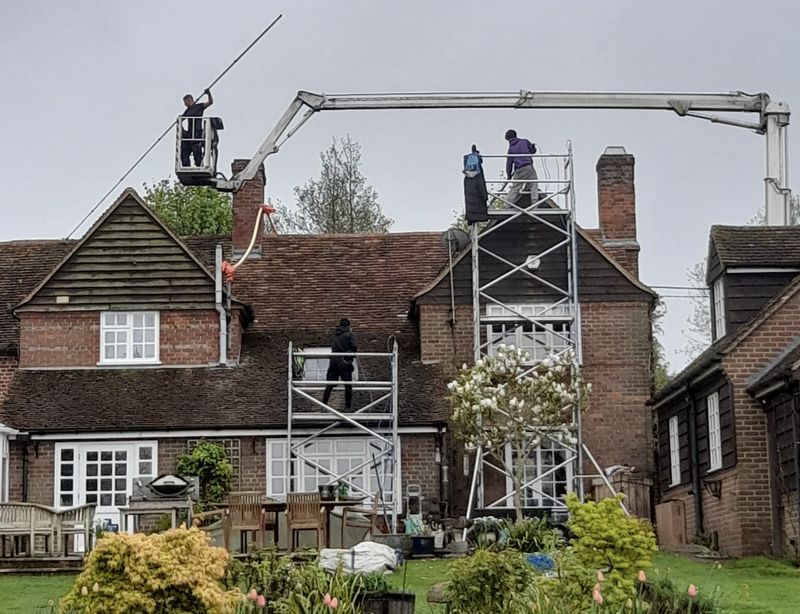 The Roof Moss Cleaners using cherry picker and scaffolding to clean roof safely and professionally in Sandhurst, Berkshire