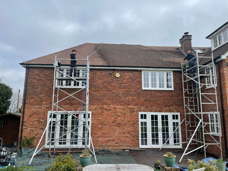 Roof cleaning carried out safely from scaffold towers by The Roof Moss Cleaners in Sandhurst